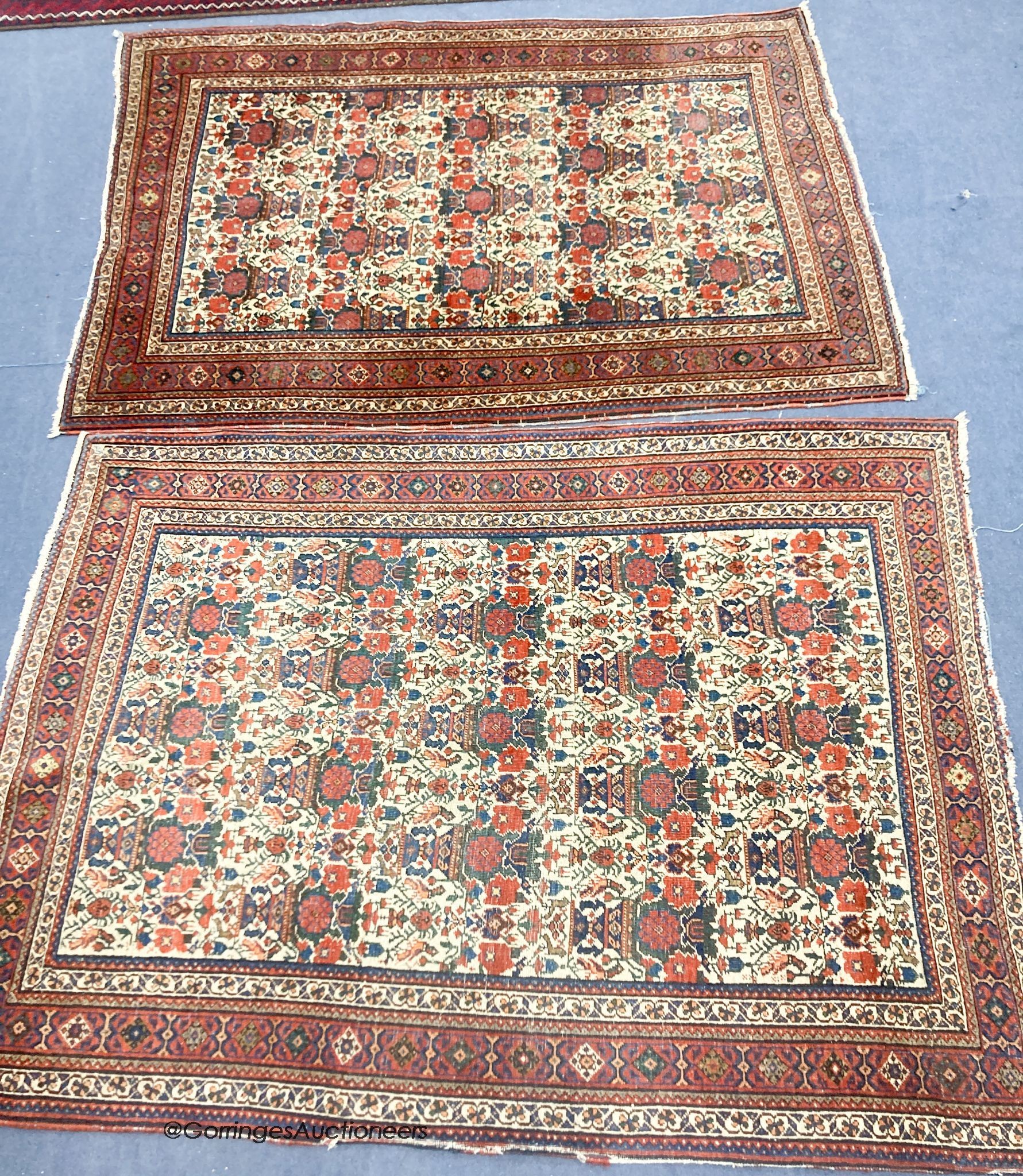 A pair of early 20th century North West Persian ivory ground rugs, woven with birds and vases of flowers, 150 x 110cm